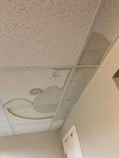 the ceiling in this room is covered with moldy paint and water spots on it