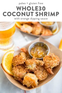 a plate full of fried coconut shrimp with orange dipping sauce