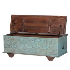 an old wooden chest with carvings on the front and sides, is shown against a white background