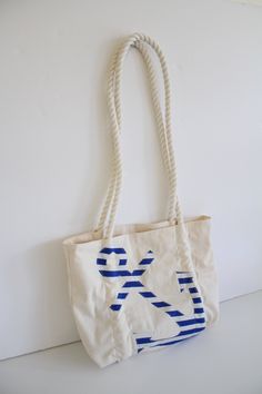 "This listing is for a One of A Kind Nautical Tote Bag Natural Cotton Dobby with polka dot cotton lining Natural Cotton Rope Straps and Striped Anchor Applique Dimensions: Length - 13\" Width - 16 1/2\" Strap length - 35\" exposed Happy Shopping!" Nautical Style Bag For Everyday Summer Use, Nautical Style Navy Bag For Everyday Use, Nautical Style Tote Bag For Vacation, Nautical Navy Bag For Everyday Use, Nautical Style Sail Color Bags For Daily Use, Everyday Nautical White Bag, White Nautical Everyday Bag, Nautical Style Everyday Tote Bag, White Nautical Summer Bags