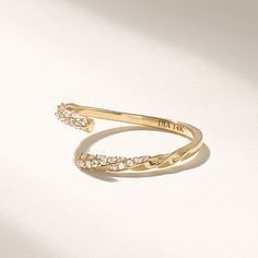 Introducing the exquisite real gold open band twisted ring, a stunning piece of jewelry that is sure to captivate anyone's attention. Crafted with precision and expertise, this pave diamond ring embodies elegance, sophistication, and timeless beauty. Made with genuine gold, this open band twisted ring showcases a modern twist on a classic design.  Features * Made to Order. * Gold KT: 10K, 14K, 18K * Custom Gold Color: Rose Gold, Yellow Gold, White Gold * Diamond Color-Clarity: D-E-F color VVS Clarity * Total CTW: 0.007ctw * Width of Band: 1.45 MM * Thickness of Band: 1.15 MM * Ready to Ship in 5-7 Business Days ✓ We care about the environment,the jewelry we cast is made with recycled gold. We source exclusively post-consumer material that is refined back to their pure elements to ensure th Luxury Engraved Open Band Ring For Wedding, Modern Twist 14k Gold Open Diamond Ring, Gold Diamond Ring With Modern Twist, Modern Twist 14k Gold Bypass Ring For Anniversary, Gold Diamond Ring With Modern Twist Open Shape, Modern Twist Gold Diamond Ring With Open Design, Modern Twist Gold Diamond Open Ring, Yellow Gold Open Ring Bypass For Promise, Gold Bypass Ring For Anniversary With Open Band