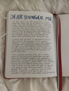 an open notebook with writing on it and the words dear younger me written in blue ink