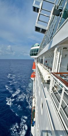 the deck of a cruise ship looking out at the ocean from it's upper deck