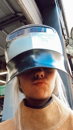 a woman with white hair wearing a helmet on her head