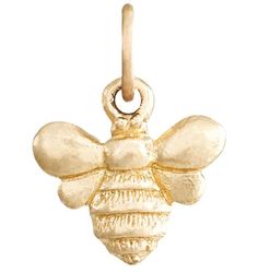 a silver charm with a bee on it