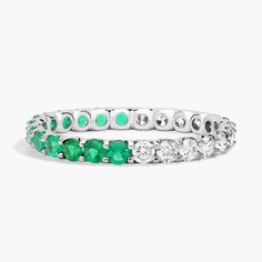 a white gold ring with emeralds and diamonds