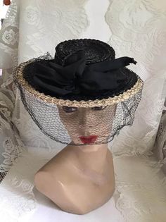 "Vintage 1940's Black and Cream straw hat with veiling. Has a label and one side reads *New York Creation* the other side reads *Consumers Protection Label*. *MORE INFORMATION BELOW* CONDITION: The veiling has numerous holes/splits in it. One of which is large (SEE PIX). On the edge of the ribbons, there is fraying. Sold As Is! MEASURES: Inside circumference~17 1/2\" Front to back~10\" Left to right~10\" **WE APOLOGIZE~BUT WE CAN NO LONGER SHIP TO GERMANY, ITALY OR SPAIN. IF ORDERS COME IN FROM Vintage Black Straw Hat With Short Brim, Vintage Black Top Hat For Church, Vintage Black Brimmed Straw Hat, Vintage Evening Straw Hat With Curved Brim, Vintage Black Top Hat For Wedding, Vintage Wide Brim Top Hat For Evening, Vintage Wide Brim Straw Hat For Evening, Vintage Black Straw Hat With Curved Brim, Vintage Straw Hat For Royal Ascot