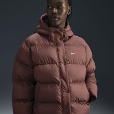 Up your outerwear game in this insulated puffer jacket. A loose fit makes it ideal for layering while the Nike Therma-FIT technology helps manage your body’s natural heat to help keep you warm in cold-weather conditions. A water-repellent finish, bungees at the hem and a hood work together to help shield you from wind and rain. Sporty Down Puffer Outerwear, Sporty Puffer Jacket With Padded Collar For Cold Weather, Sporty Down Puffer Jacket With Detachable Hood, Sporty Nylon Puffer Parka, Down Puffer Jacket With Double-lined Hood For Winter Sports, Winter Sports Puffer Jacket With Detachable Hood, Winter Sports Down Puffer Jacket With Detachable Hood, Sporty Puffer Jacket With Adjustable Hood For Cold Weather, Down Puffer Jacket For Winter Sports