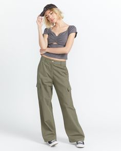 Volcom's Cargstone (Color) Pants are the ultimate in rugged yet refined style. Crafted from durable 100% cotton ripstop fabric, these wide-leg cargo pants feature roomy pockets and a relaxed, adjustable fit that's perfect for any outdoor adventure. Featured here in army green combo.Features 100% Cotton ripstop, 190gm/2 Wide leg cargo pant Slant pockets at front On leg cargo pockets with hidden button detail and double piping back pockets with hidden button button detail Adjustable drawcord at an Military Style Relaxed Fit Cargo Pants With Belt Loops, Military Style Relaxed Fit Cargo Pants With Elastic Waistband, Military Style Green Cargo Pants With Patch Pockets, Military Cotton Cargo Pants With Flap Pockets, Double Piping, Olive Military Cargo Pants With Patch Pockets, Script Embroidery, Stone Embroidery, Color Pants