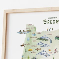 a watercolor map of oregon is shown in a wooden frame