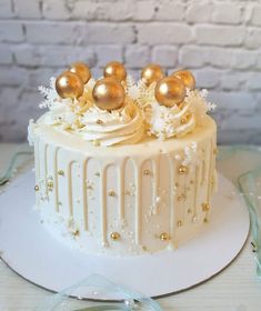 a white cake with gold decorations on top