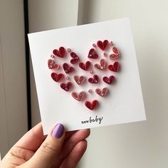 someone holding up a card with hearts on it