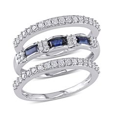 Watch her eyes light up when you give her this stunning blue sapphire and diamond 3-piece stackable ring Set. Crafted in lustrous 10k white gold, the center ring features 3 baguette-cut blue sapphire gemstones with 16 round, prong-set diamonds sparkling along the sides. The other two rings are shimmering with 18 round, prong-set diamonds along each band. The set is enhanced with a high polish finish and will lend an eye-catching touch of sparkle to your loved one's look. This ring measures 9mm i White Gold Stackable Rings, White Gold Bridal Set, Stackable Ring Sets, Diamond Baguette, Sapphire Rings, White Gold Sapphire, Bridal Ring Sets, Man Made Diamonds, Blue Sapphire Rings