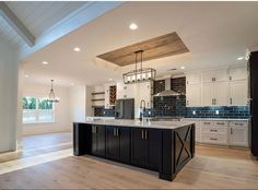 a large kitchen with an island in the middle