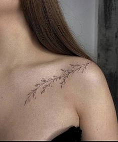 the back of a woman's shoulder with small flowers on her left arm and chest