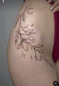 a woman's stomach with an artistic tattoo design on the side, and leaves