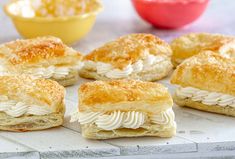 several biscuits with cream cheese on them sitting on a counter