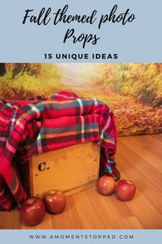 some apples are laying on top of a wooden box with the words fall themed photo props