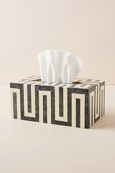 a tissue dispenser sitting on top of a table