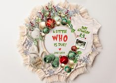 a baby's first christmas ornament is surrounded by ornaments and other items