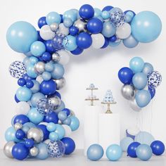 a blue and silver balloon arch for a baby's first birthday party with balloons