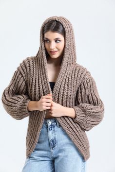 Stay cozy in style this season with our must-have chunky cardigan! Made with premium hand-knit wool and featuring on-trend balloon sleeves, this oversize cardigan is the perfect addition to your fall wardrobe. Whether you're dressing it up or down, it's versatile enough to be worn with anything from jeans to dresses. The open front design and hoodie add extra comfort and warmth on chilly days. And best of all, it's lovingly handcrafted with the utmost care and attention to detail. It's also a perfect Mother's Day gift for your mom, who will appreciate the handmade craftsmanship and thoughtful design. Crochet Knit Cardigan Size Guide : Country/Size ... S/M  M/L  L/XL USA & CAN : .... 2 - 6  6 - 10  10 - 14 EU :  34-38 .... 38-42  42-46 UK & AUS :  6-10  10-14  14-18 Made of highest quality Hand Knit Cardigan, Balloon Sleeve Cardigan, Oversize Cardigan, Cardigan Brown, Brown Hoodie, Cardigan Crochet, Chunky Cardigan, Gifts For Your Mom, Oversized Cardigan