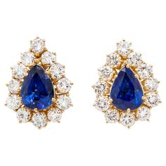 Expertly crafted in warm and radiant 18 carat yellow gold, these spectacular pear shaped stud earrings are a staple to every jewellery collection. Each earring features a captivating royal blue pear shape sapphire at its centre, weighing 4.84ct combined, radiating with deep, mesmerising hues that exude elegance with every movement. Surrounding the sapphires is a beautiful halo of 12 round brilliant cut diamonds, enhancing the beauty of the gemstones and creating a delightful contrast between the Luxury Pear-shaped Sapphire Earrings, Blue Pear-shaped Fine Jewelry Earrings, Formal Blue Pear-shaped Diamond Earrings, Blue Pear-shaped Diamond Earrings For Anniversary, Sapphire Pear-shaped Fine Jewelry Earrings, Fine Jewelry Sapphire Pear-shaped Earrings, Gem Setting, Yellow Gold Stud Earrings, Blue Sapphire Diamond