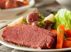 a white plate topped with meat and vegetables