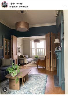 a living room filled with furniture and a wooden coffee table on top of a blue rug