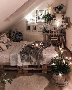 an attic bedroom decorated with plants and lights