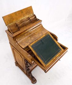 an old wooden desk with a green pad on it's top and drawer open