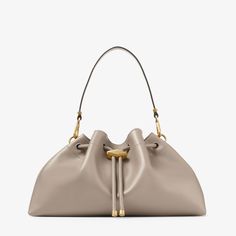 Inspired by contrasts – the Cinch M handbag is an evolutionary piece in our Bon Bon family defined by a soft and effortless silhouette that is cinched by a faceted Diamond drawstring closure. This definitive style is crafted from soft calf leather and is complemented by gold-tone hardware. Bridal Flat Sandals, Jimmy Choo Bags, The Cinch, Cinch Bag, Bridal Handbags, Bridesmaid Bags, Sneaker Dress Shoes, Bon Bon, Boot Bag