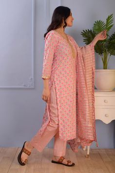 Pink cotton silk kurta with floral block print motifs all over and embroidered neckline. Comes with straight fit pant and dupatta.
Component: 3
Pattern: Print and Embroidery
Type Of Work: Floral
Neckline: V Neck
Sleeve Type: Three quarter
Fabric: Kurta- Cotton Silk;
Pant- Cotton Satin;
Dupatta- Viscose Stripe Organza 
Color: Pink
Other Details: 
Block print
Scallop embroidered neckline
Organza striped dupatta
Occasion: Puja - Aza Fashions Satin Dupatta, Print Motifs, Kurta Cotton, Floral Block Print, Silk Pant, Straight Fit Pants, Silk Kurta, Embroidered Neckline, Kurta Set