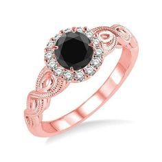 a rose gold ring with an oval black diamond surrounded by small white and pink diamonds