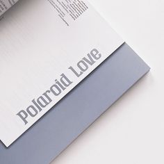 an open book with the word polaroid love written on it's front cover