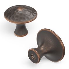 two bronze colored knobs on an isolated white background