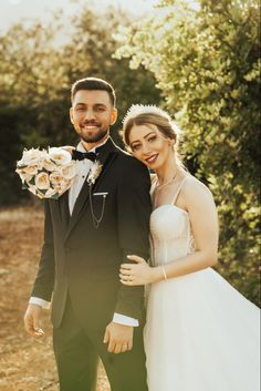 a bride and groom pose for a wedding photo