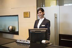 a woman standing behind a counter in an office