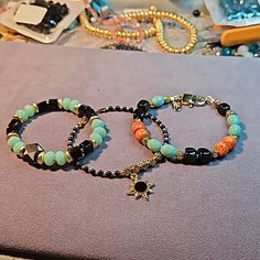 This Handcrafted Three Bracelet Set Features A Mix Of Light Jade Green, Black Onyx, Brass And 14k Gold-Filled Beads In A Variety Of Shapes. You'll Enjoy Wearing Them Through All Seasons. Whether It's White Linen, That Black Turtle Neck, Or Your Favorite Denim, You'll Step Out In Style. Sized 7" To 7.25" Wrist. Black Bracelets With Spacer Beads, Black Bohemian Bracelets With Faceted Beads, Spiritual Green Onyx Gemstone Beads Jewelry, Black Onyx 8mm Beads Stretch Bracelet, Luxury Onyx Bracelet With 8mm Beads, Elegant Hand-strung Onyx Beaded Bracelets, Hand-strung Multicolor Jade Beaded Bracelets, Black Turtle Neck, Tiffany Bracelets