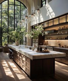 a large kitchen with an island and lots of counter space in front of the windows