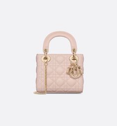 The Lady Dior bag embodies Dior's vision of elegance and beauty. Sleek and refined, the timeless and modern style is crafted in powder pink lambskin with Cannage stitching, creating the instantly recognizable quilted texture. The D.I.O.R. charms embellished in transparent tonal resin highlight its silhouette. Featuring a removable chain shoulder strap, the miniature Lady Dior bag can be carried by hand, worn over the shoulder or crossbody as an ideal evening wear companion.. Mini Lady Dior, Wardrobe Makeover, Micro Bag, Dior Book Tote, Christian Dior Couture, Dior Couture, Bag Luxury, Backpack Tote Bag, Powder Pink