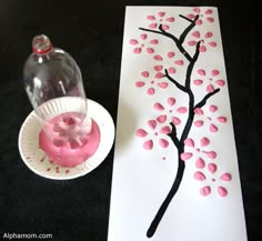 a paper plate with pink icing on it next to a painting and a vase