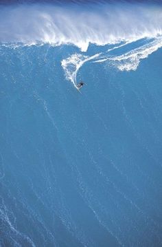 a man riding a wave on top of a surfboard