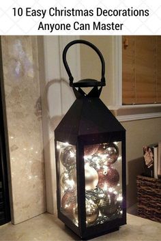 a lantern is lit up with christmas ornaments