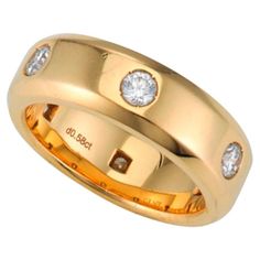 a yellow gold wedding ring with three diamonds