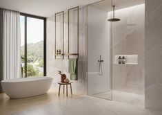 a bathroom with a tub, shower and window