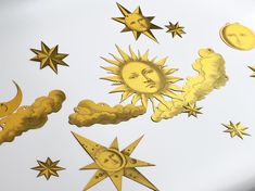 the sun, moon and stars are drawn in gold foil