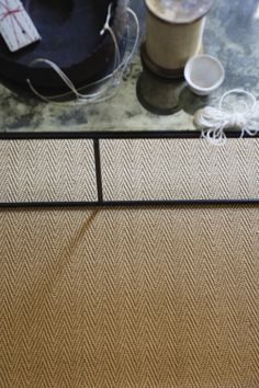 a close up of a coffee table with some items on the top and one cup