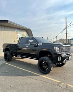 a black truck parked in front of a building