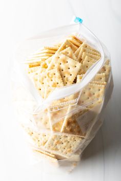 several crackers in plastic bags on a white surface